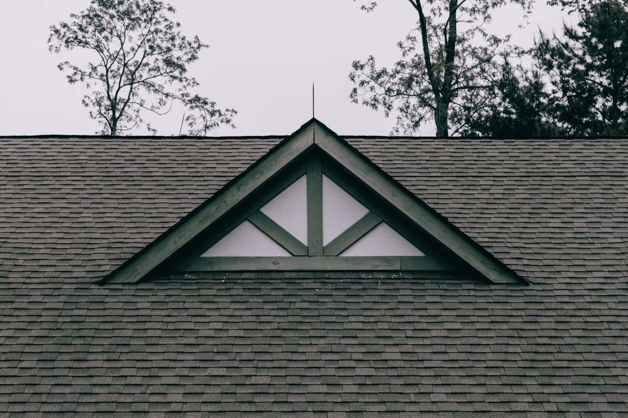 A shingle roof with a gable vent.